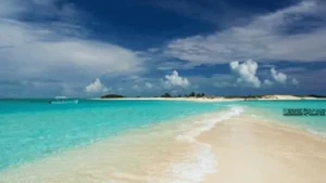 Turquoise water and sandy shoreline in Los Roques Archipelago with a boat