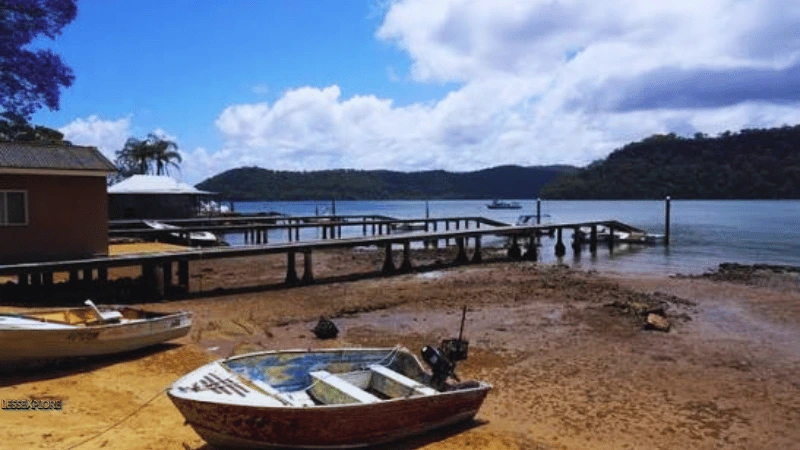 Beached boats at low tide on Dangar Island NSW shoreline