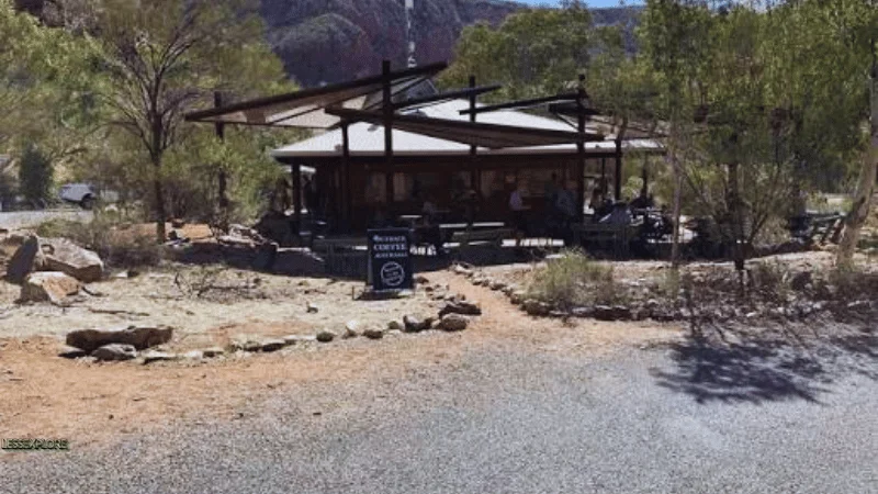 Wooden kiosk with shade sails and a coffee sign near the Ormiston Gorge walking trails