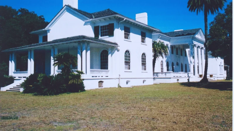 Plum Orchard Mansion side wing exterior with chimney and porch